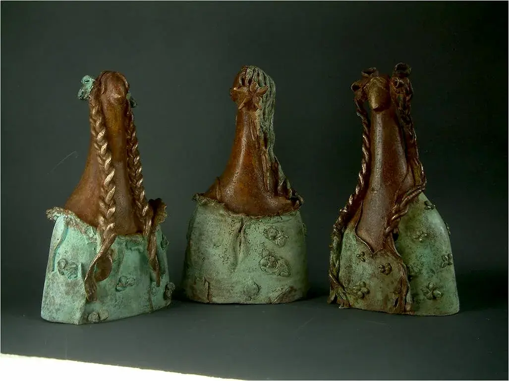 Three bronze portrait busts with braided hair and mint-patina bodices